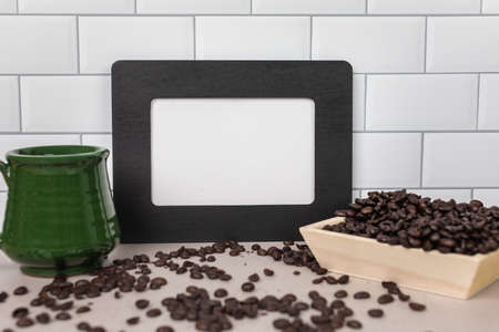 Blank empty no words on white sign in black frame whole coffee beans and green tea cupの写真素材
