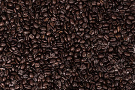 Close up texture background of dark brown roasted whole coffee beans
