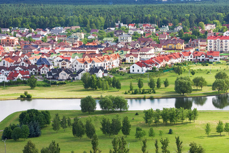 Beautiful and tidy living quarters in Minsk, Belarus cituated near green park and river. White houses with red roofsの写真素材