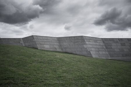 High stone wall on a green hill.の写真素材