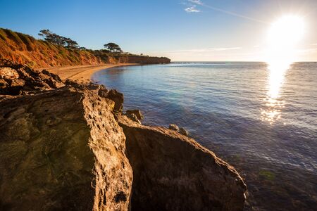 Seascape of Sunset overlooking house on a cliff.の写真素材