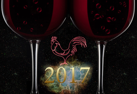 Two red wine glasses with wine on black backgroundの写真素材