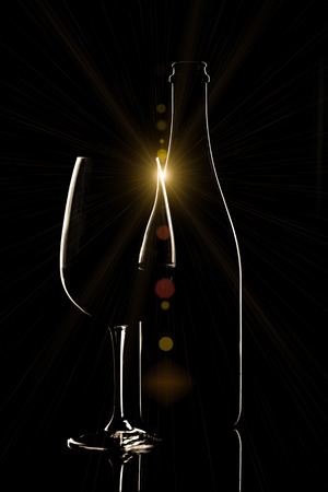 Red wine bottle and wine glass on black backgroundの写真素材
