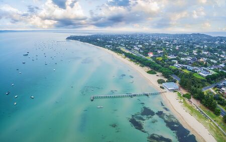 Aerial view of beautiful coastline of Mornington Peninsula near Sorrento suburb showcasing Long Pier and The Baths restaurant. Melbourne, Victoria, Australiaの写真素材