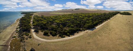 Kangaroo Island aerial panorama - winding rural road, trees, and pastures