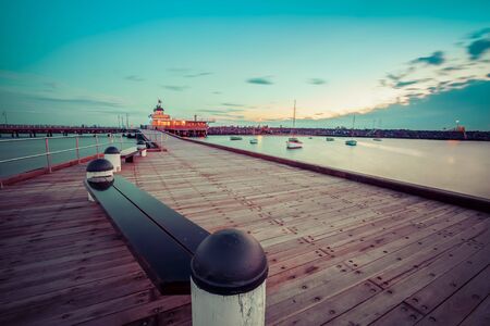 St. Kilda Pier at Dusk with boats in the harbour, and Pavilion in the distance. Melbourne, Australiaの写真素材