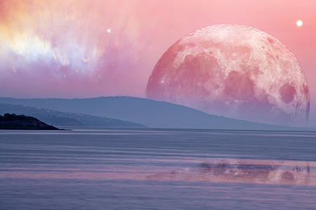 Landscape of an alien planet - huge pink moon reflects in calm ocean water. Elements of this image...