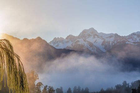 View of Southern Alps from lake Matheson in the early morning mist. South Island, New Zealand.の写真素材