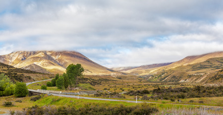 Magnificent views of yellow hills from the Great Alpine Highway, Canterbury, New Zealandの写真素材