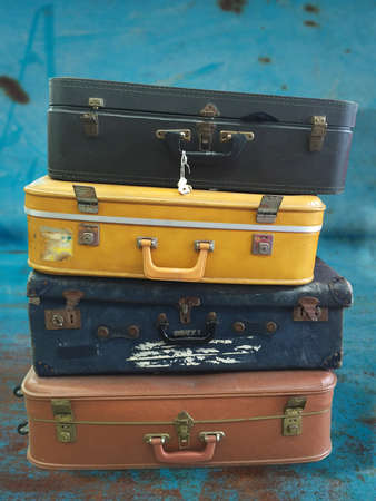 Stack of vintage suitcases on grungy rusty backgroundの写真素材