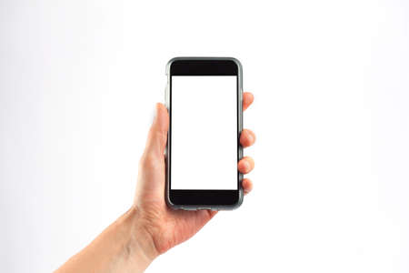 Female hand holding a mobile phone in vertical orientation. Isolated on white background with white screen.の写真素材