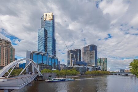 MELBOURNE - JAN 31 2016: View of Yarra river, Eureka Tower, Southbank footbridge, and Melbourne river cruises boat.のeditorial素材