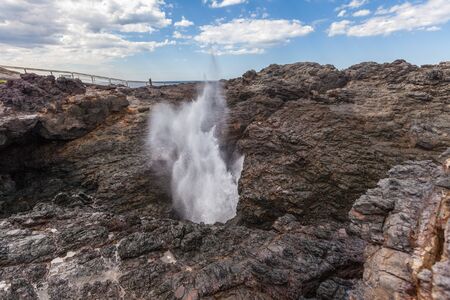 Water spraying out in force from the Kiama Blowhole near Sydney Australiaの写真素材