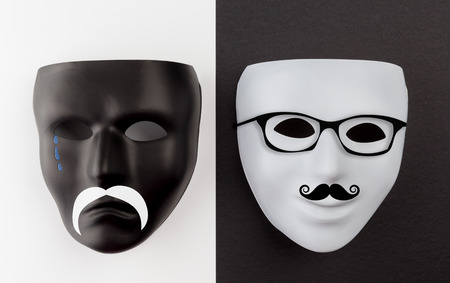 Black sad and white happy masks with mustache and glassesの写真素材