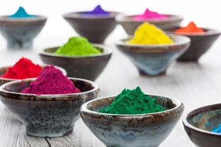 Holi powder in cups with selective focusの写真素材