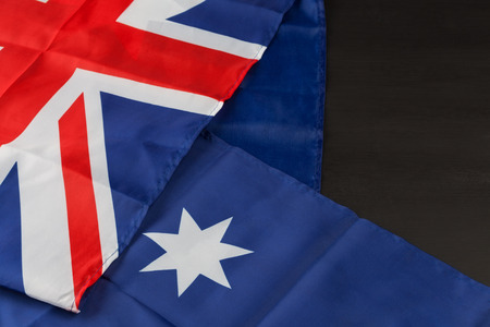 Folded Australian flag on black background with copy spaceの写真素材