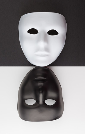 Black and white masks upside down on contrasting backgrounds, Personality change conceptの写真素材