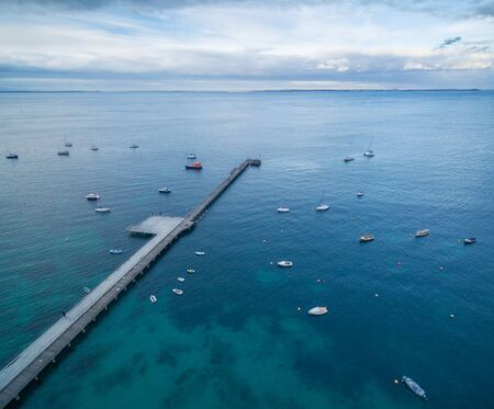 Aerial view of Flinders pier with moored fishing boats at dusk, Mornington Peninsula, Melbourne, Victoria, Australiaの写真素材