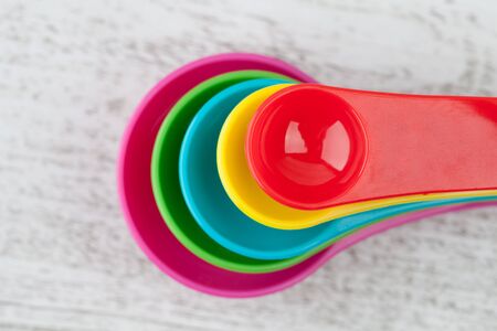 Colorful measuring spoons symmetrically placed closeupの写真素材