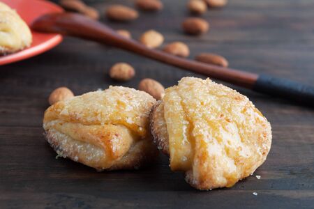 Sweet cottage cheese cookies closeup with almonds in the background. Shallow depth of fieldの写真素材