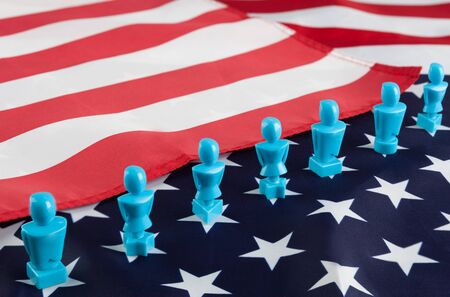 Male and Female figurines on USA flag. Voting, elections, equality, patriotism, independence conceptの写真素材
