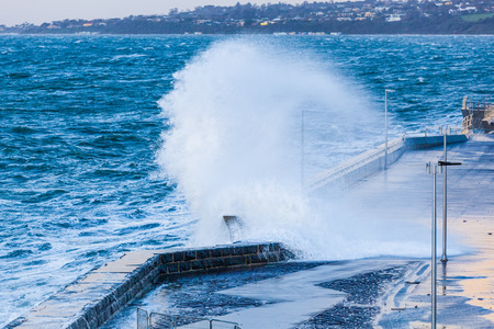 Huge wave crushing on Mornington Pier. Melbourne, Victoria, Australiaの写真素材