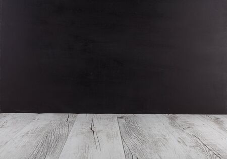 White rustic wood table with black background. Horizontal image with copy spaceの写真素材