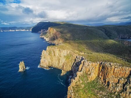 Rugged cliffs of Cape Hauy on bright sunny day aerial view. Tasman National Park, Tasmania, Australiaの写真素材