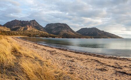 The Hazards Mountain Range viewed from Coles bay at sunset. Freycinet National Park, Tasmania, Australiaの写真素材