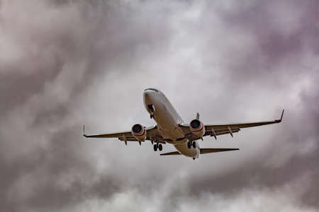 Melbourne, Australia - January 2, 2017: Passenger jet airplane low in the sky preparing to land with...