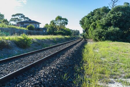 Rail tracks winding into the distance in rural areaの写真素材