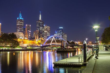 Melbourne CBD - APR 17 2016: Cityscape at night with Southbank footbridge over yarra river and Flinders street station.のeditorial素材