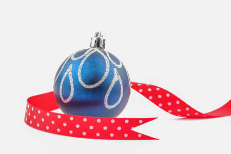 Christmas bauble with red dotted ribbon isolated on white.の写真素材