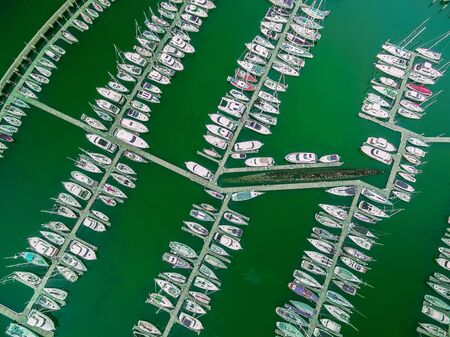 Looking straight down at moored sailboats and old decommissioned submarine. Aerial view.の写真素材