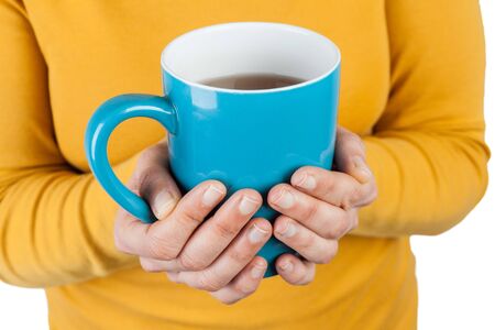 female hands holding a big cup of tea closeup with copy spaceの写真素材