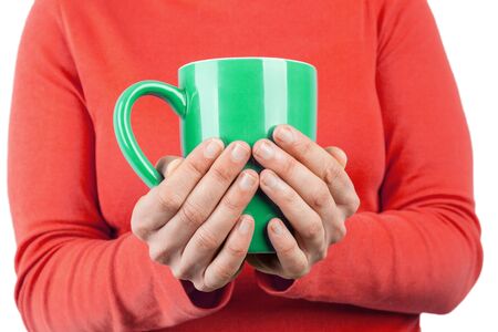 female hands holding a big cup of tea closeup with copy spaceの写真素材