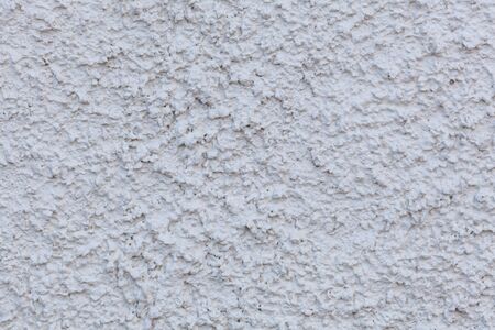 White painted cement wal background pattern extreme closeupの写真素材