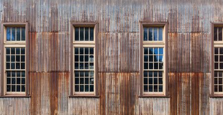 Old rusty metal shed with tall windows closeupの写真素材