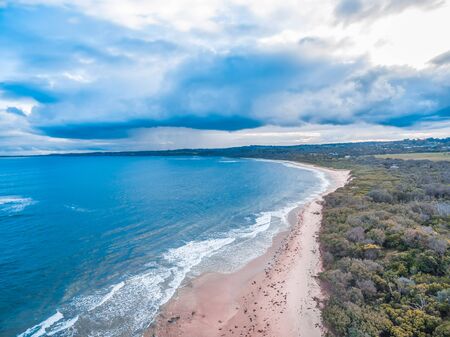 Aerial view of storm cloud over ocean coastlineの写真素材