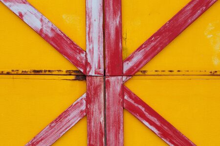 Red and yellow painted wooden planks backgroundの写真素材