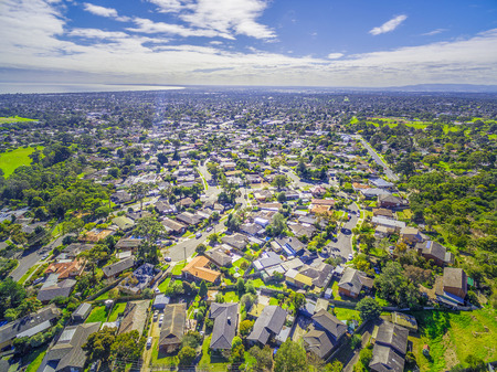 Aerial panorama of town houses near ocean bay on bright sunny dayの写真素材