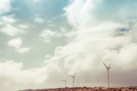 Wind turbines and stormy weather - renewable energy conceptの写真素材
