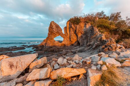 Beautiful Australia Rock at Narooma, NSW, Australia glowing in orange sunsetの写真素材