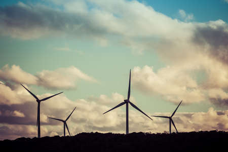 Silhouettes of four wind turbines at beautiful sunset.の写真素材