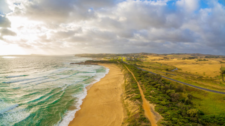 Glowing sunset over ocean coastline in Australia - aerial viewの写真素材