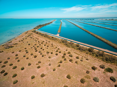 Wastewater treatment plant pools near ocean coastlineの写真素材
