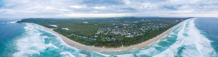 Wide aerial panorama of ocean coastline and Suffolk Park suburb in New South Wales, Australiaの写真素材