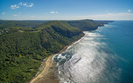 Aerial panorama of beautiful ocean coastline on bright sunny day near Grand Pacific Drive, Sydney, Australiaの写真素材