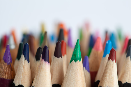 Rows of sharp colored pencils with focus on foreground