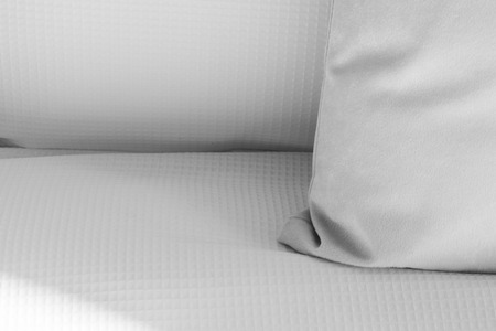 Close-up shot of white pillow on a bed with copy space